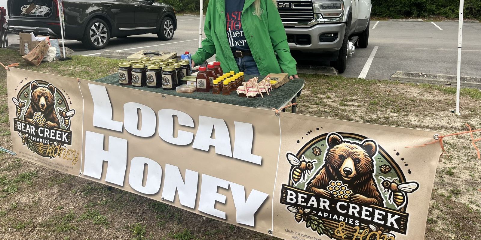 Our roadside honey stand in Gadsden County, Florida — jars of raw local honey and comb on the table